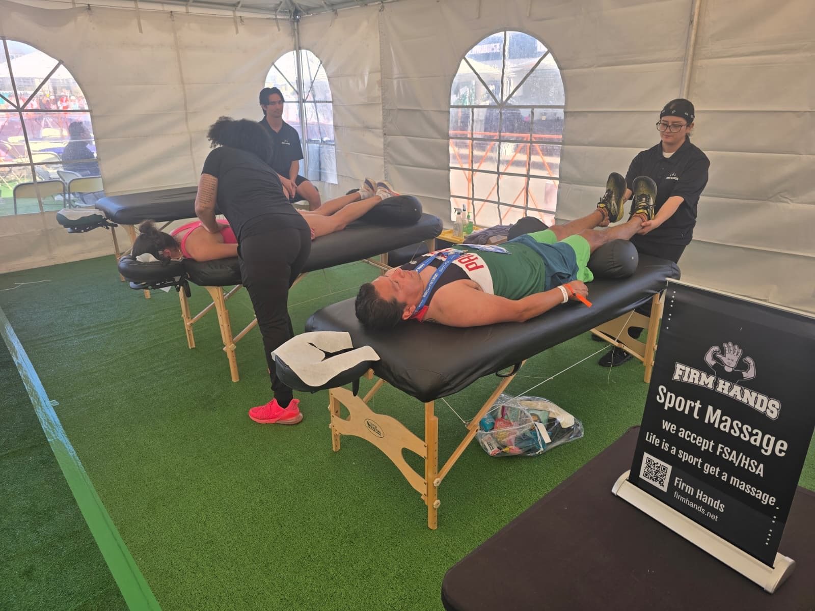 Runners still wearing race bibs lying on the tables for leg work